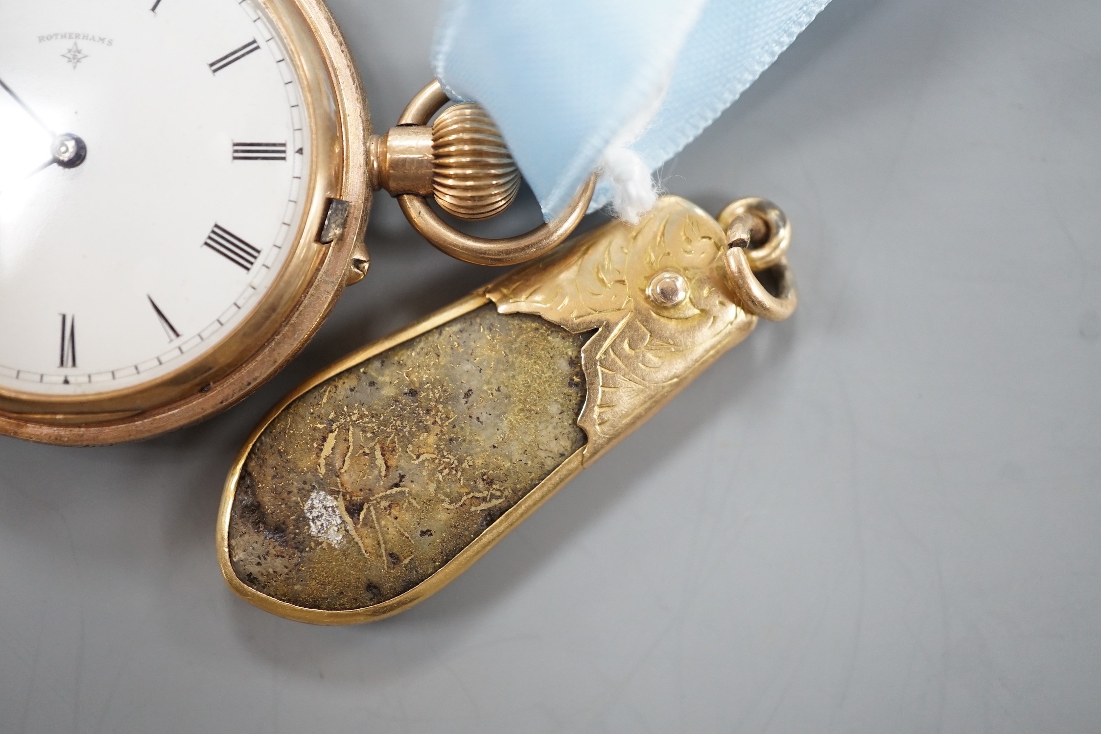 An early 20th century engraved 9ct gold hunter fob watch, with Roman dial, gross 36.7 grams, on a blue sash with yellow metal mounted hardstone fob.